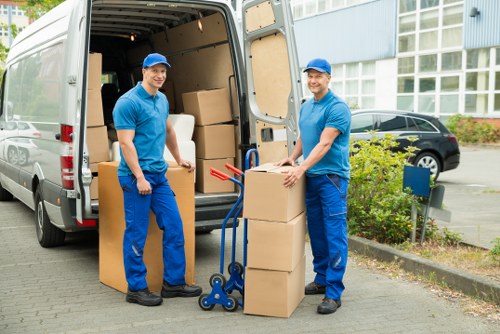 Removal crew handling commercial furniture in a Highbury property